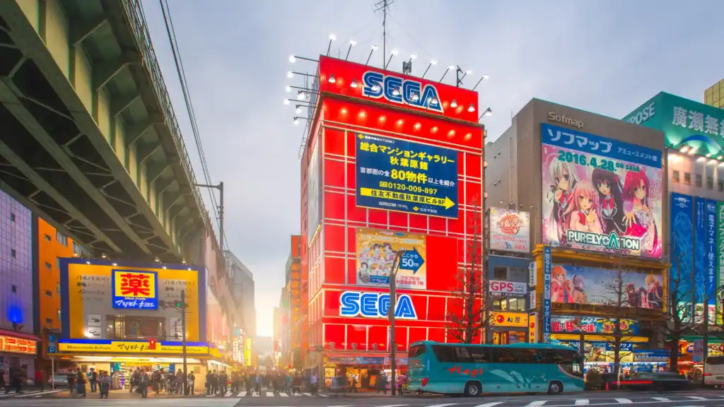 Tokyo travel experiences in Akihabara with SEGA building, anime billboards, and neon city streets.