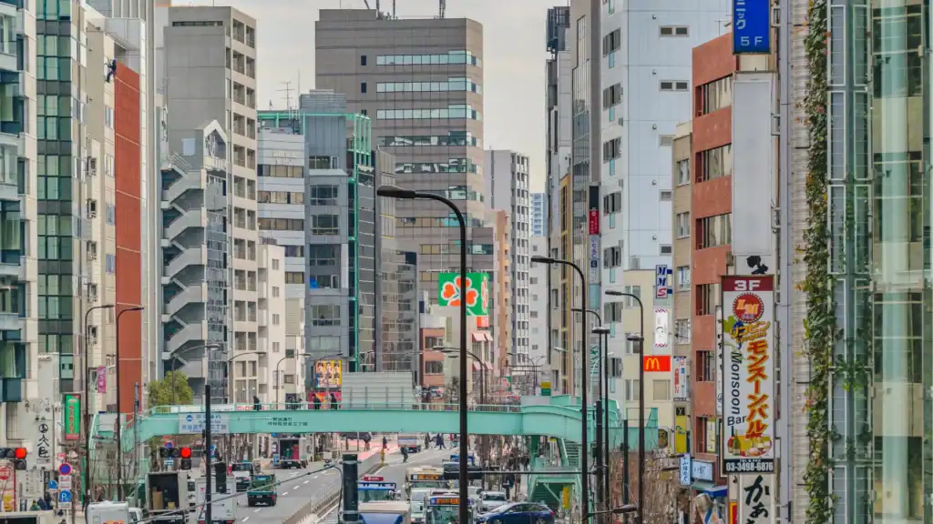 Busy central Tokyo city street with buildings and traffic, everyday things to do in Tokyo