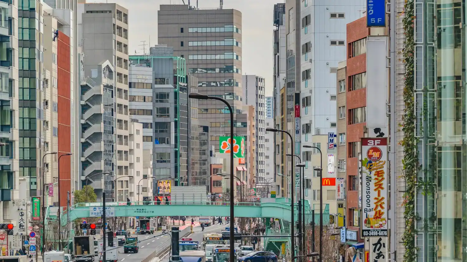 Busy central Tokyo city street with buildings and traffic, everyday things to do in Tokyo