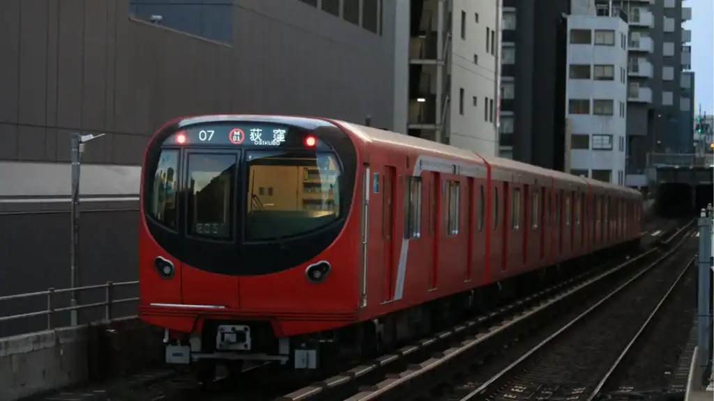 Tokyo travel experiences using a Tokyo subway train arriving at an urban station.