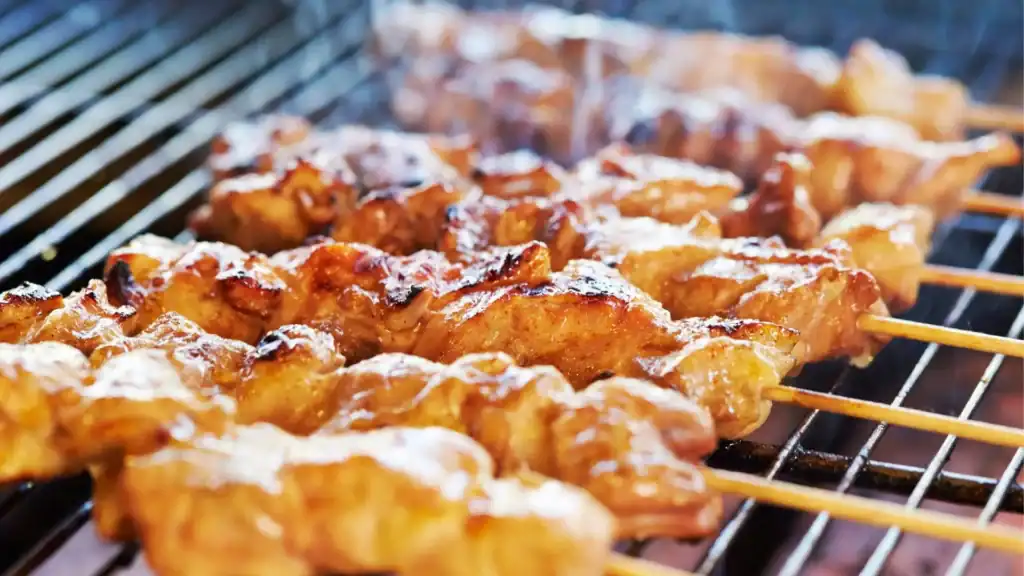 Charcoal-grilled yakitori skewers, a must-try Japanese food made from juicy chicken pieces cooked over open flame.