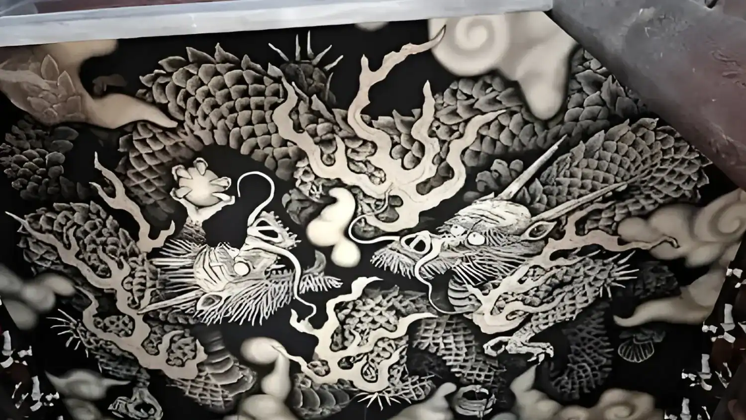 Ceiling artwork of two dragons at Kennin-ji Temple, showing detailed scales, swirling clouds, and strong flowing lines in black and white in 2 Day Kyoto Itinerary. 