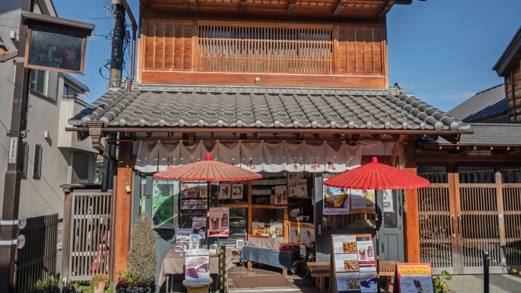 Traditional Japanese storefront in a quiet neighborhood, reflecting everyday life and volunteer opportunities in Japan through local routines and community spaces.