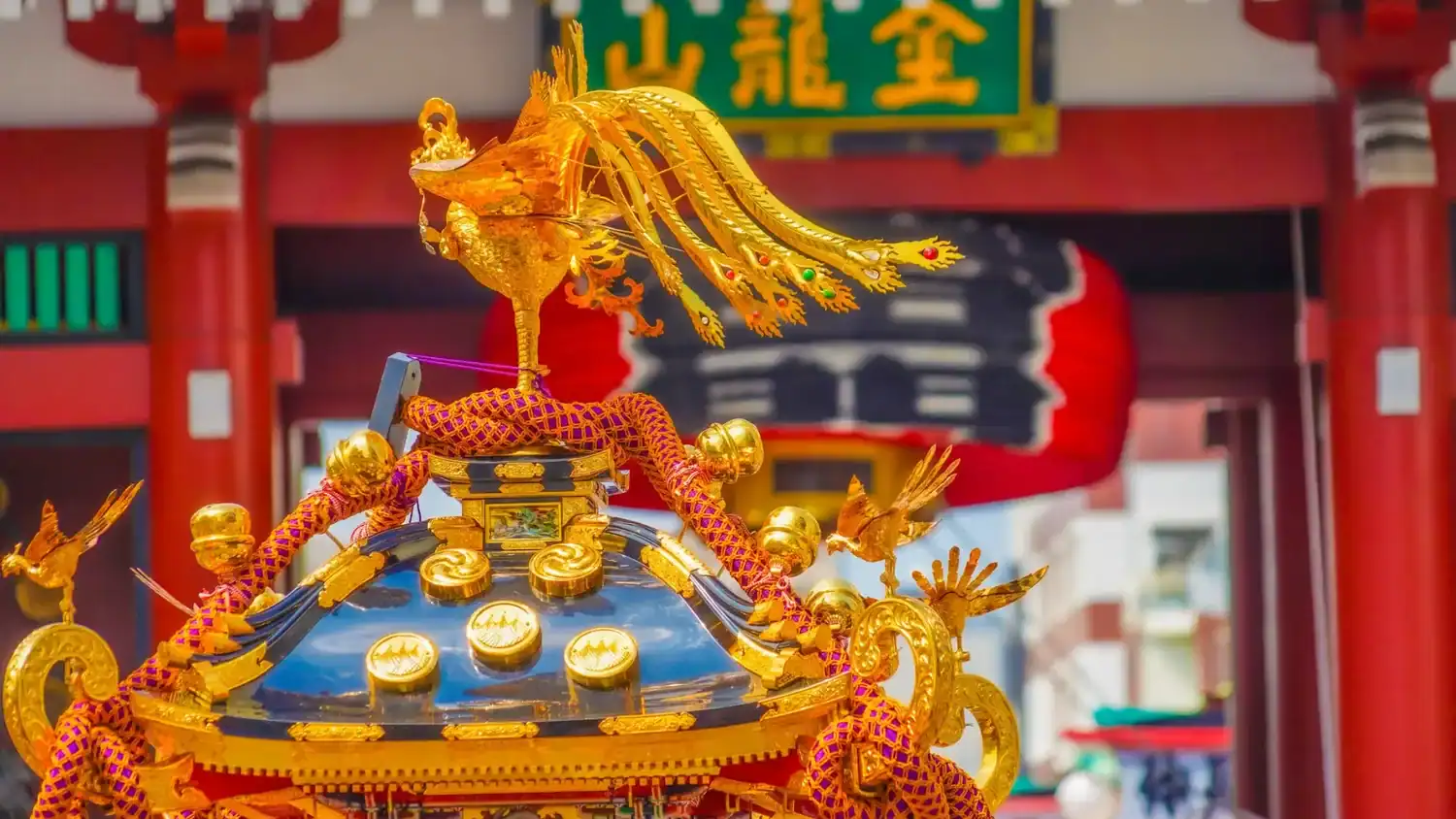Traditional festivals in Japan featuring a mikoshi adorned with a golden phoenix during a shrine procession.
