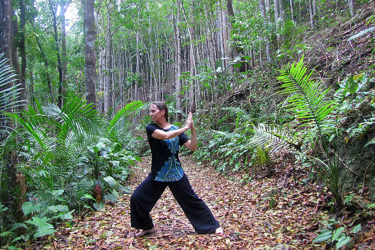 A woman in traditional clothing demonstrates various yoga poses in Bohol's highlands as part of a Philippine yoga retreat.
