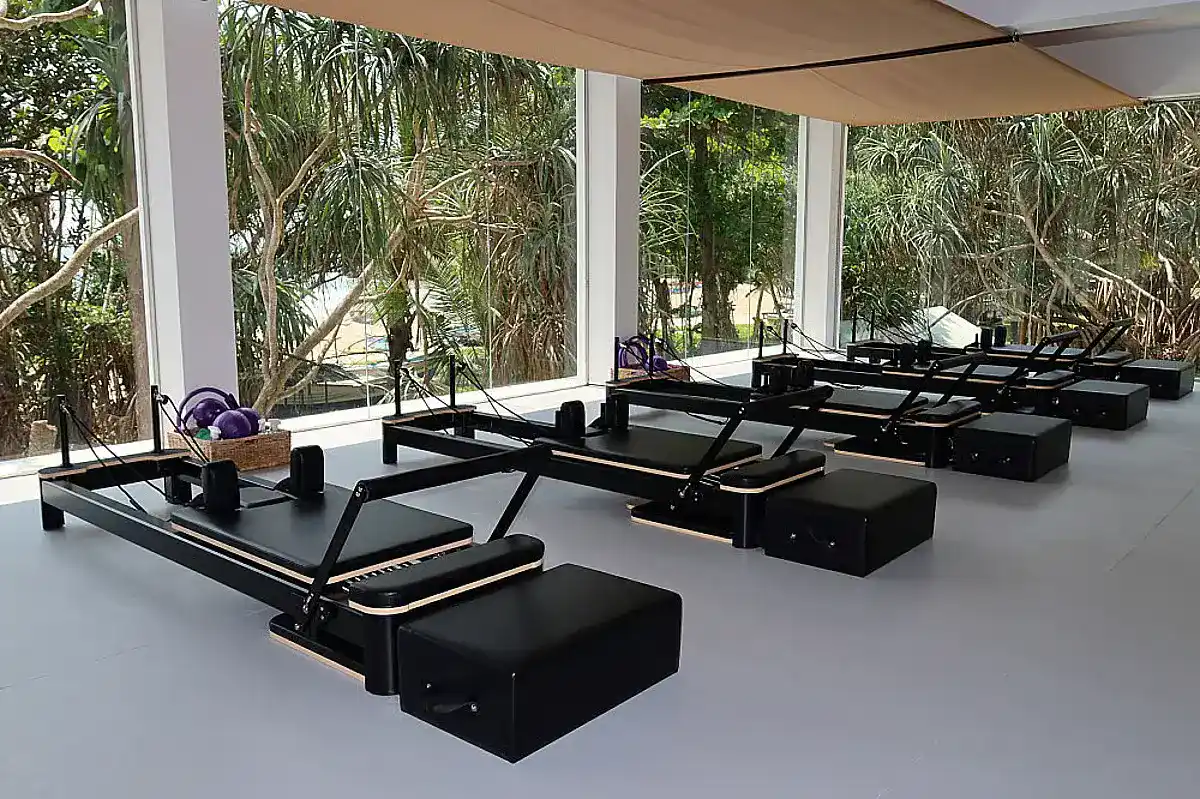 Rows of black pilates equipment.
