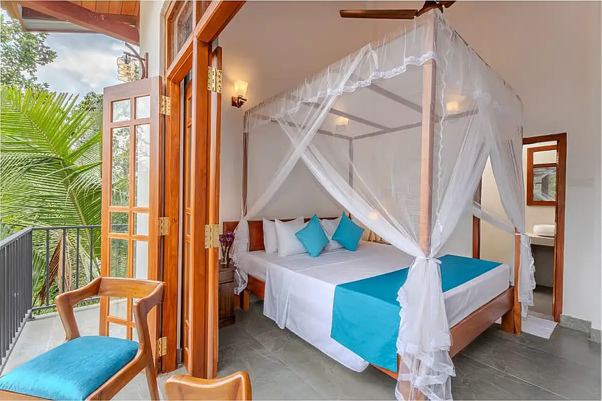 A cream and turquoise bedroom inside YogaBee, a yoga retreat in Sri Lanka. 