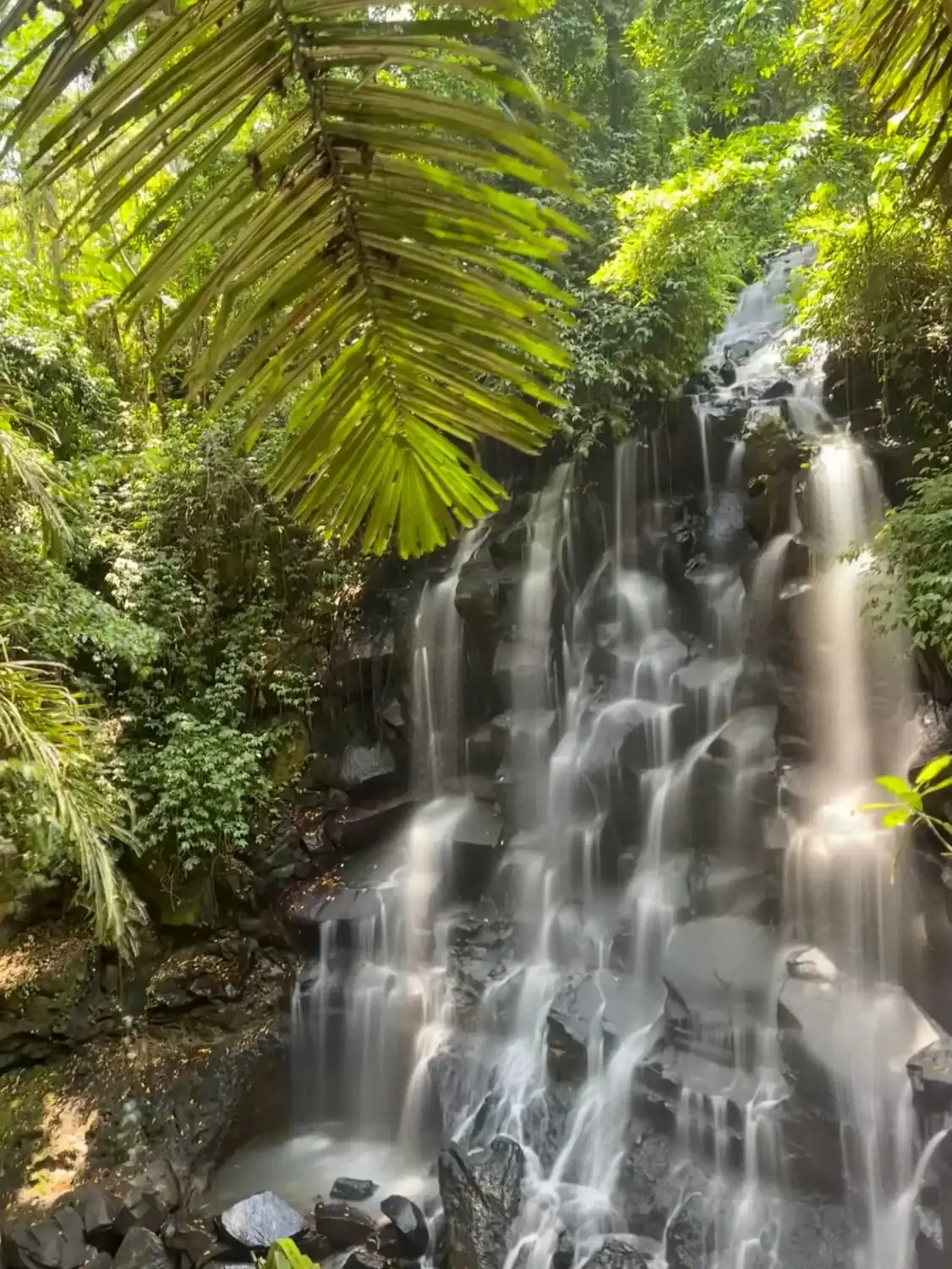 Kanto Lampo Waterfall cascading through jungle greenery