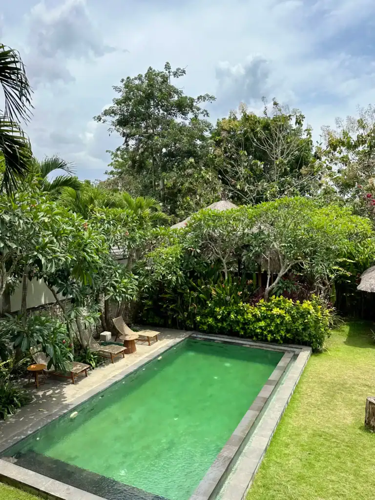 Private pool villa in Uluwatu, Bali surrounded by tropical garden and lounge chairs, one of the best options for where to stay in Bali for couples seeking privacy.