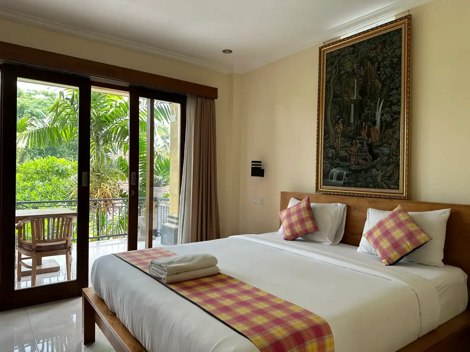 Spacious bedroom at Yudha Ubud with balcony and garden views, a peaceful option for where to stay in Bali near central Ubud.