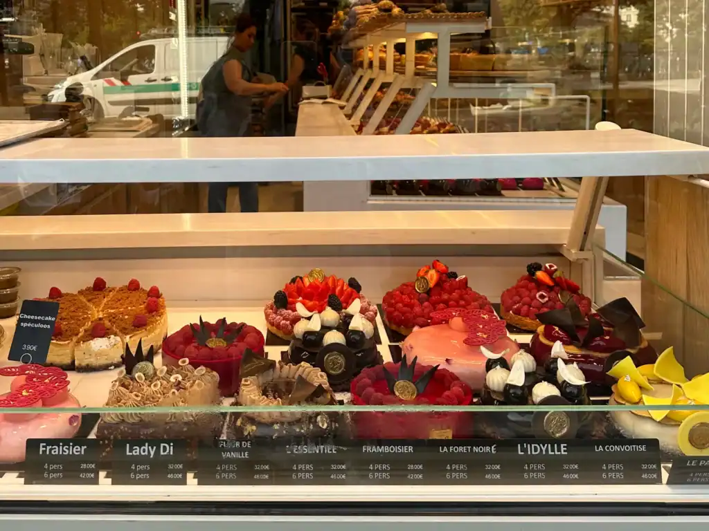 Volunteer in Paris: Colorful cakes and pastries displayed in the window of a Parisian bakery.