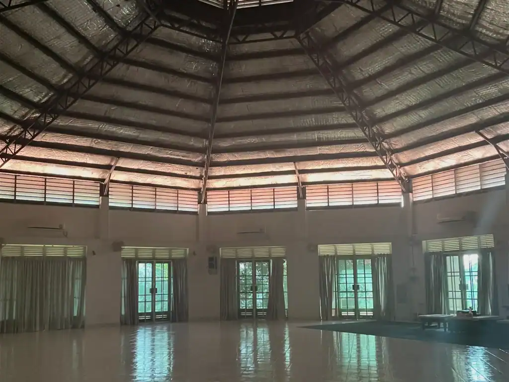 Volunteer in Thailand at a meditation center featuring a spacious circular hall designed for mindfulness retreats and community gatherings.